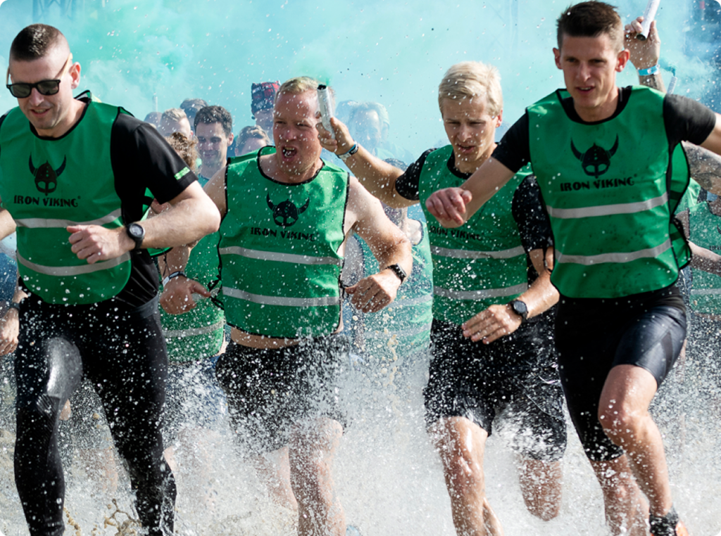 Participants of the Iron Viking running through the water.