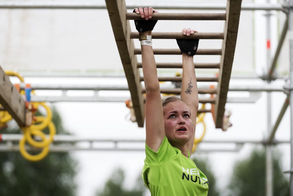 Strong viking participant hanging from the monkey bars