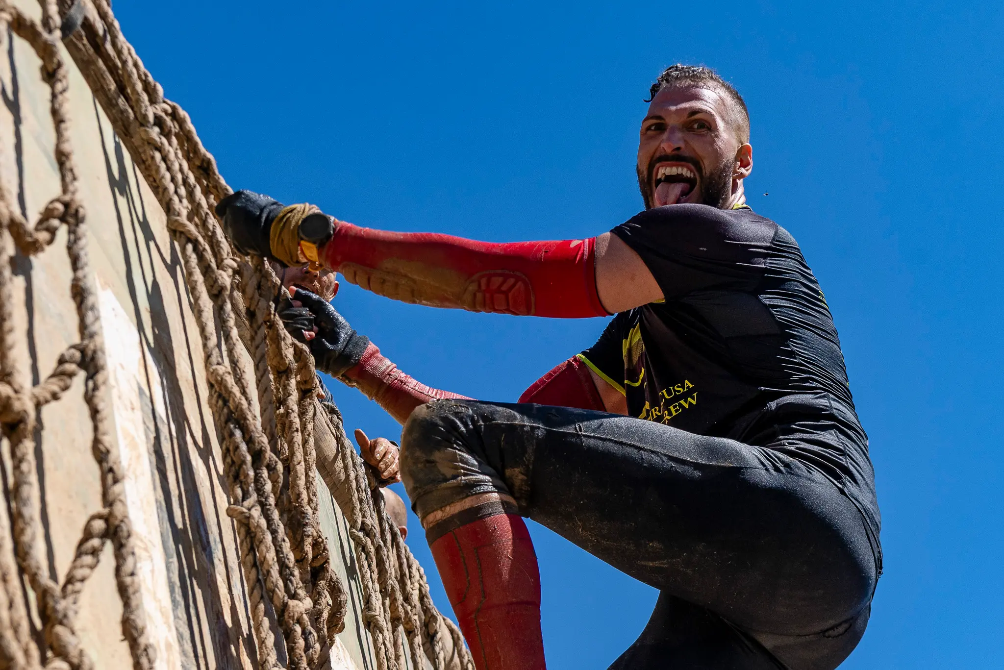 man climbing on obstacle during strong viking